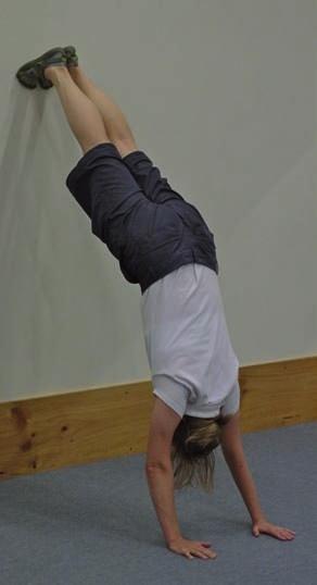 The focus is on: * getting used to being upside down * building arm and shoulder strength * getting the open shoulder angle; that is, a straight line from the heel of the hand through elbows,