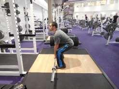 your legs to stand position while holding barbell till full standing