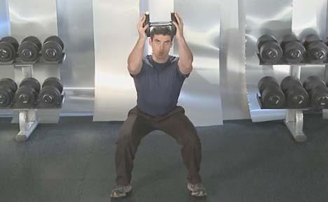 GIANT SET 3: 1. Squat with Horizontal Dumbbell 3 Position Press at Bottom x 10 reps Squat down and back, holding the dumbbell horizontally in front of the chest with both hands.