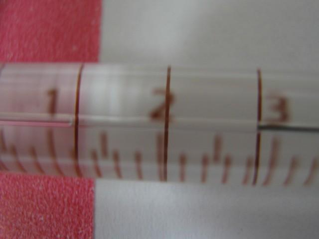 With 3-4uL of liquid in the syringe, hold the needle vertically or at least slanted upwards so any air bubbles will rise toward the needle.
