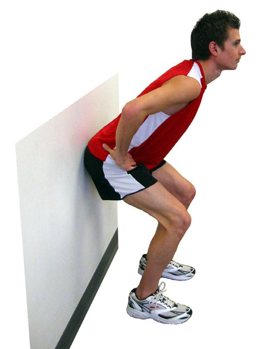Butt-Wall Squat Standing with your back to the wall take one step forward. Stand with your feet shoulder width apart and your toes pointing straight.