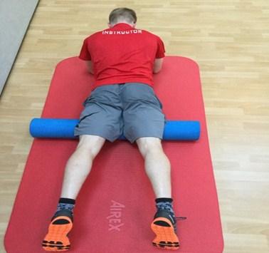 Bend the other knee so the supporting foot is in contact with the floor but set away from the foam roller.