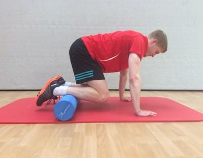 Maintaining spinal posture, take the knees towards your chest allowing the roller to move