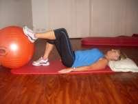 Lie on your stomach with your knees bent and lower legs resting against the ball. Gently tense your bottom muscles without moving and keeping the back of your legs (hamstrings) relaxed.