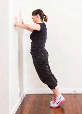 From a standing position, place both hands on the wall, shoulder-width