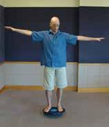 LEVEL 2 DOUBLE LEG WOBBLE BOARD: Participant stands with both feet on a wobble board surface.