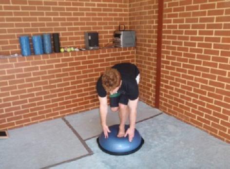 Stand back up and then bend down and touch both hands on the BOSU.