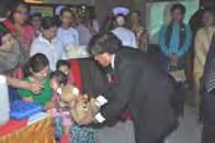 President of MMCWA, Dr. Mon Mon Aung, cheering the child getting measles vaccine Dr. H.S.
