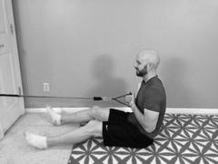 Seated Low Back Exercise with Exercise bands! Start: Sit on the floor, legs out in front of you.