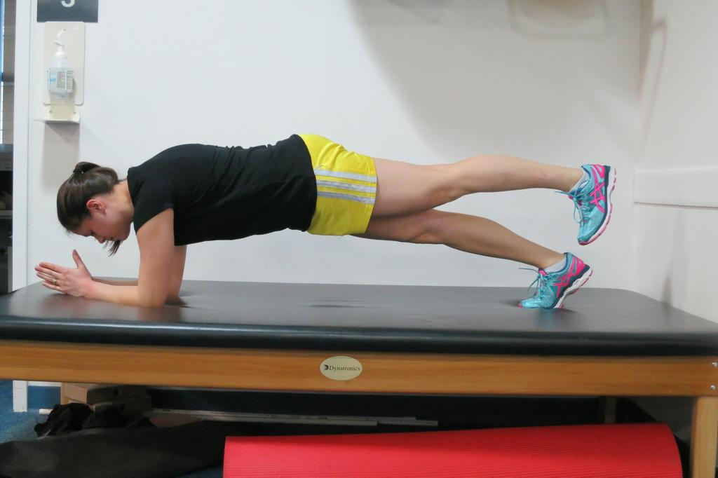 Prone plank with alternating leg lifts While keeping your abdominals and glutes tight, back flat, and hips