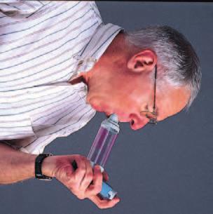 Place the mouthpiece in your mouth, then press the inhaler button to release a puff of medicine into the spacer