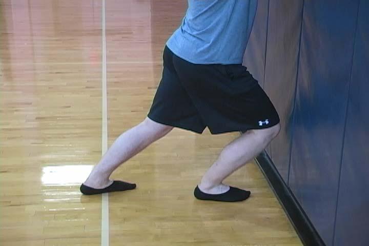 CLOSED CHAIN ANKLE DORSIFLEXION Purpose To assess ankle dorsiflexion with the knee flexed and the foot on the ground. Without wearing shoes, stand facing a wall with the foot pointed at the wall.