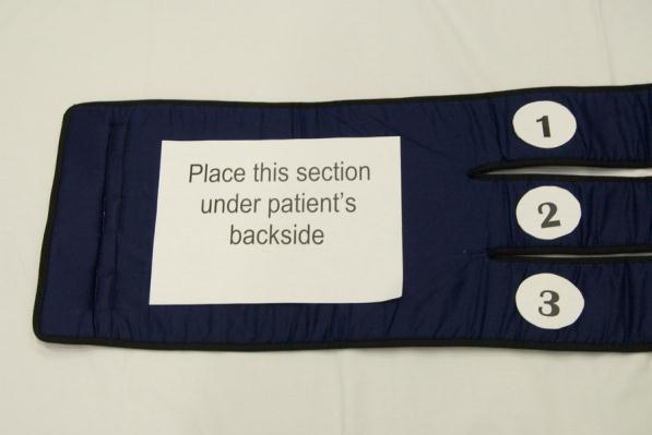 clips and remove the velcro straps to enable the long straps to be rolled small enough to pass under the patient