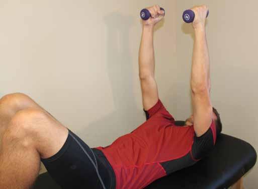 Hold light dumb bells (1-5 pounds max.) in hands and extend arms directly over shoulders, arms straight throughout the movement.