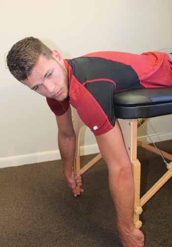 Neck Prone Extension - Oblique A. Prone with arms over edge of table and holding legs of table, head is lowered. B.