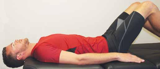 Lie supine (face up) on a table, bench or bed.