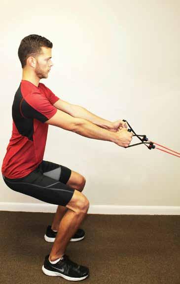 Stand with feet shoulder-width apart, toes facing forward, holding the handles of the band.