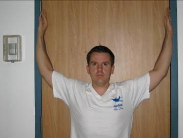 RETRACTION WITH OVERHEAD RAISE Assume the arm and shoulder blade position described in the retraction exercise at the top of the page.