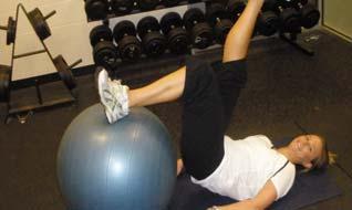Ball. Lie on your back with your hands by your sides. Place your left calf on top of the ball.