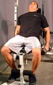 Incline Inner Biceps Curl Tips: Lie back on an incline bench and hold dumbells at arm's length, palms in.