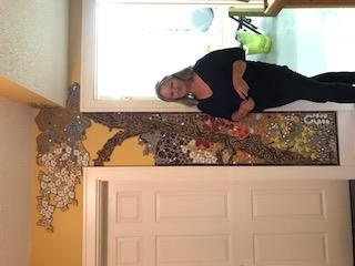 On the wall by the door of her studio was a breathtaking tree with flowers made of tiles incorporated into the wall.