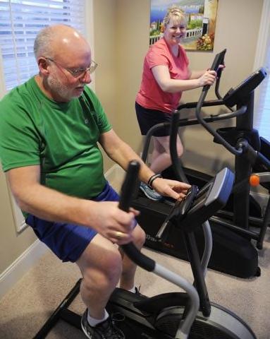Keith Scott exercising with his girl friend Julie Gabhart in her home gym near Robards recently.