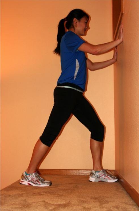 Calf Stretch - Option 1 Rest your hands against a sturdy object such as a wall or counter Position the target leg behind you with foot flat on the floor, toes pointing straight ahead and