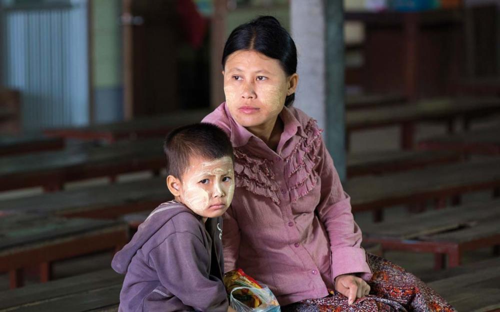 This Burmese mother and her child, who has symptoms of malaria, are waiting to be seen at the Wang Pha clinic.