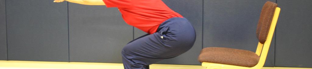 Hamstrings Stand in front of a sturdy