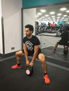 Grip the kettle bell with your hands between your legs and lower your hips, keeping your head and chest up.