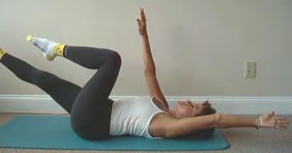 Slowly straighten one leg out and raise the opposite arm over head to the floor