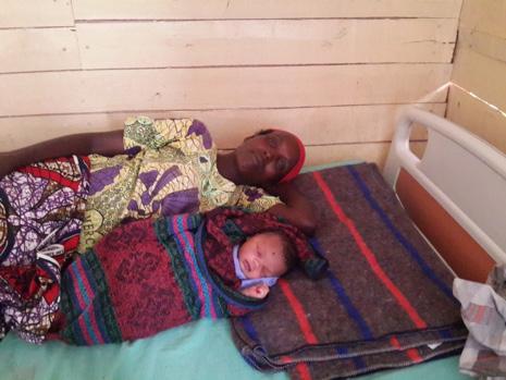 My baby and I are safe and warmly covered says Kamaliza Anonciate a Burundian refugee in Mahama camp. Kamaliza gave birth on the day of UNFPA team visit early January, 2016.