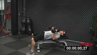 For the dumbbell squat, hold a dumbbell in each hand on the outside of your legs. Keep your low back arched. Do NOT round your low back.