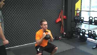 Goblet Squat Stand with your feet just greater than shoulder-width apart.