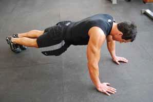 Push Up (Spiderman) Starting in a standard push up position Hands