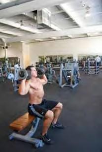 Bench Squat & Press Standing with feet slightly wider than shoulder width apart standing about 6 inches in front of a bench Holding dumbbells at your shoulders palms facing away from your body or