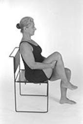 Knee Up Stretch 1. Sit comfortably with knees bent and feet flat on the floor. Keep your back straight and hands at your sides. 2.