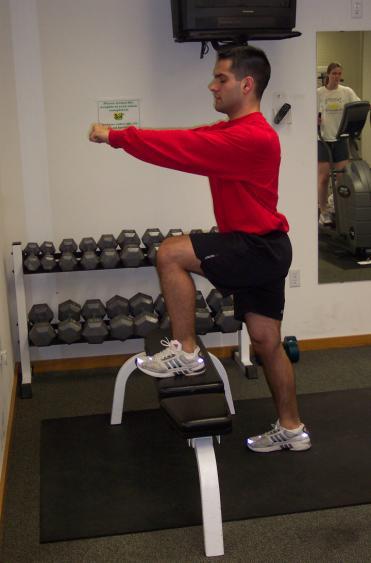 VI. Step-Ups: Step-ups begin with one foot completely on a bench or 18 inch box (Fig 6.a).