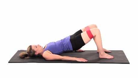 Bridge with Hip Abduction and Resistance - Ground Touches Begin lying on your back with your feet resting on the ground, arms by your sides, and a resistance band looped around your legs above your