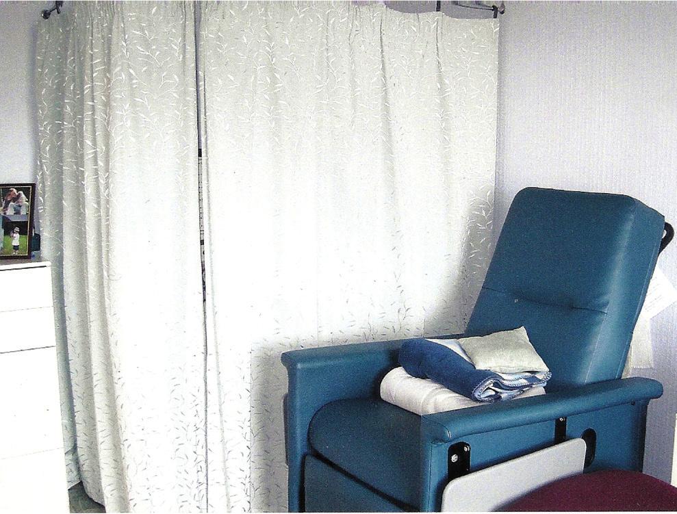 When the patient is not dialysing, He draws the curtain across to cover the dialysis machine and water unit as