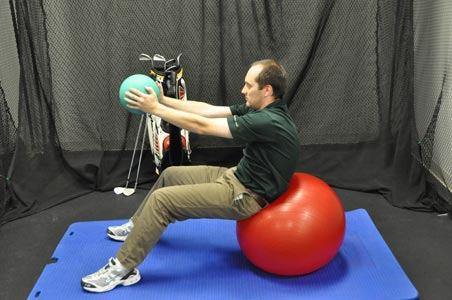 Grab one dumbbell and sit on a Swiss ball. Stabilizing the dumbbell on your chest, slowly walk yourself out on the ball until the ball is directly under the arch of your lower back.