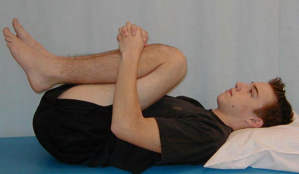 Lumbar Paravertebrals 1. Lie on your back with your knees bent. 2. Raise your right leg and hold it with your right hand below the knee then repeat with the left leg holding with the left hand. 3.