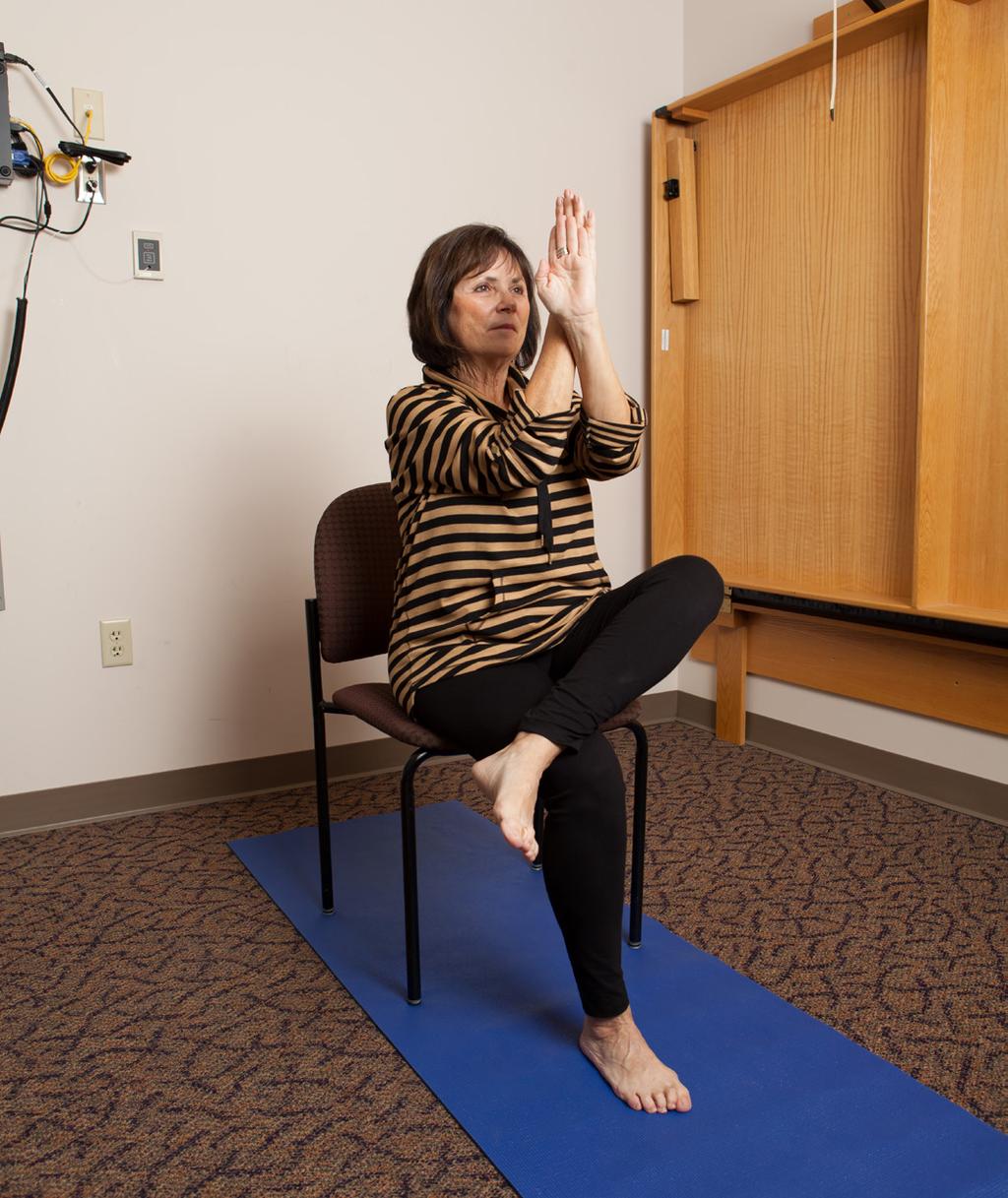 Eagle Position VGY Sit toward front of chair, your back away from back of chair. Cross left leg over right; wrap legs tightly. Bring elbows to meet chest height.