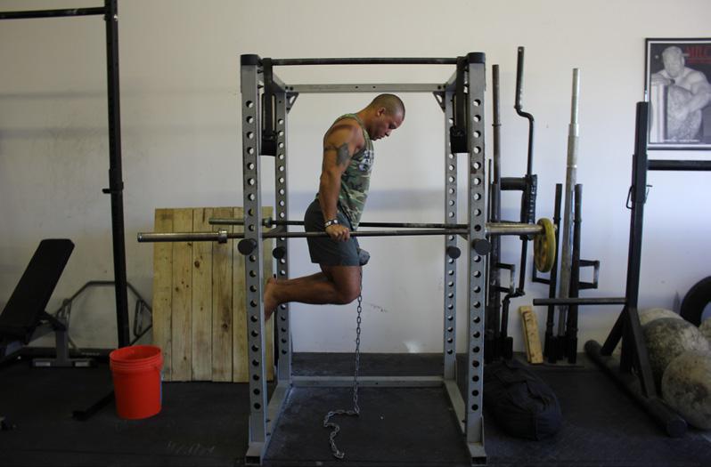 Keeping your elbows in towards your body, press the bar back up into the locked out top position.
