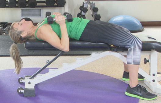 Extend back to the top position then lower the dumbbells to