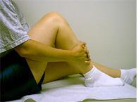 In later stages of rehabilitation, do heel slides by grasping the leg with both hands and pulling the heel toward the buttocks. See Figure 5.