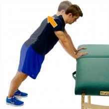 Table Plank Plus Start in a push up position leaning up against a table or counter top as shown.