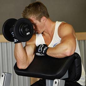 As you breathe in, slowly lower the dumbbell until your upper arm is extended and the biceps is fully stretched. 3.