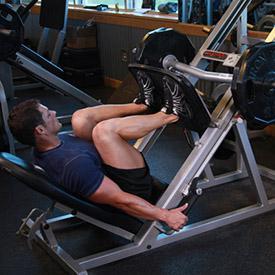 positioning section). 2. Lower the safety bars holding the weighted platform in place and press the platform all the way up until your legs are fully extended in front of you.