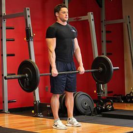 Keeping the knees stationary, lower the barbell to over the top of your feet by bending at the hips while keeping your back straight.